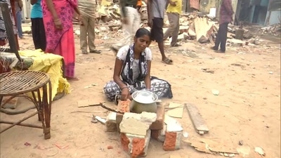 Priya, whose house was demolished during the anti-encroachment drive in Chennai, cooks her food on the road.&nbsp; (Twitter/ANI)