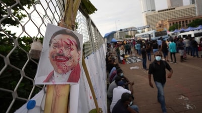 A disfigured portrait of Prime Minister Mahinda Rajapaksa is seen at a protest site outside president's office in Colombo, Sri Lanka. (AP) A disfigured portrait of Prime Minister Mahinda Rajapaksa is seen at a protest site outside president's office in Colombo, Sri Lanka. (AP)