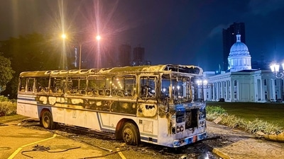 Charred remains of a bus is pictured near Sri Lanka's outgoing Prime Minister Mahinda Rajapaksa's official residence in Colombo. (AFP for representation) Charred remains of a bus is pictured near Sri Lanka's outgoing Prime Minister Mahinda Rajapaksa's official residence in Colombo. (AFP for representation)