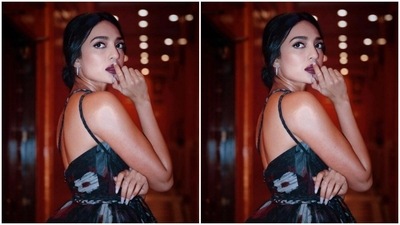 Sobhita’s black satin top came with floral patterns in white and red. The top featured frill details at the waist and a dramatic throw in the one side. (Instagram/@sobhitad)