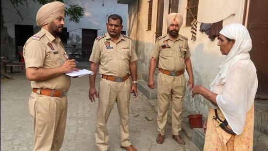 Cops speaking to neighbours in the Ludhiana locality where the crime took place on late Sunday night. (HT Photo)