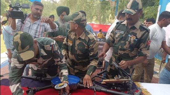 Border Security Force personnel displaying the drone from Pakistan that was shot down near Bharopal village of Amritsar district on Monday. The BSF also recovered 10.6kg of heroin it was carrying. (Sameer Sehgal/HT)