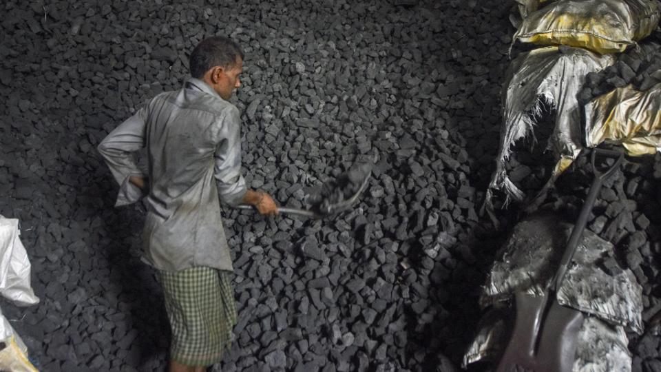 Mumbai: A worker loads coal into a sack at a coal wholesale market in Mumbai, Monday, May 9, 2022. (PTI Photo)(PTI05_09_2022_000178B) (PTI)