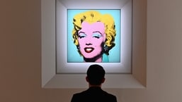 In this file photo taken on April 29, 2022 a man looks at Andy Warhol's 'Shot Sage Blue Marilyn' during Christie's 20th and 21st Century Art press preview at Christie's New York in New York City.&nbsp;