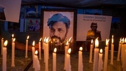 In this picture taken on July 17, 2021, journalists in New Delhi, India, light candles and pay tribute to Reuters photographer Danish Siddiqui.