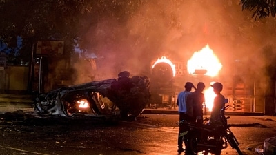 A bus burns close to Sri Lanka's outgoing Prime Minister Mahinda Rajapaksa's official residence, in Colombo on Monday. (AFP) A bus burns close to Sri Lanka's outgoing Prime Minister Mahinda Rajapaksa's official residence, in Colombo on Monday. (AFP)