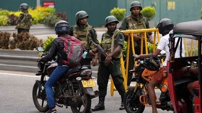 Sri Lankan army soldiers stand guard as motorists cross a checkpoint in Colombo, Sri Lanka, Tuesday, May 10, 2022. (AP Photo/Eranga Jayawardena) (AP) Sri Lankan army soldiers stand guard as motorists cross a checkpoint in Colombo, Sri Lanka, Tuesday, May 10, 2022. (AP Photo/Eranga Jayawardena) (AP)