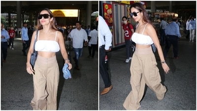 Malaika chose a breezy cotton fit in neutral shades. It features a statement crop top in a solid white shade. It comes with barely-there straps, a square neckline, cropped hem flaunting the star's toned midriff, a billowy silhouette creating a breezy effect, and ruched details on the torso. (HT Photo/Varinder Chawla)