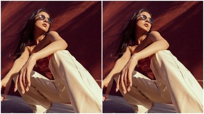 Shehnaaz paired a leather corset maroon top with a pair of white leather trousers. (Instagram/@shehnaazgill)