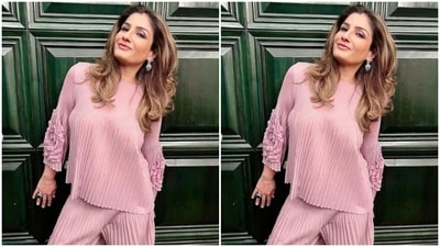 Raveena paired a shimmery satin pastel pink top with a pair of pastel pink trousers. (Instagram/@officialraveenatandon)