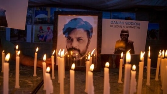 In this picture taken on July 17, 2021, journalists in New Delhi, India, light candles and pay tribute to Reuters photographer Danish Siddiqui.(AP)