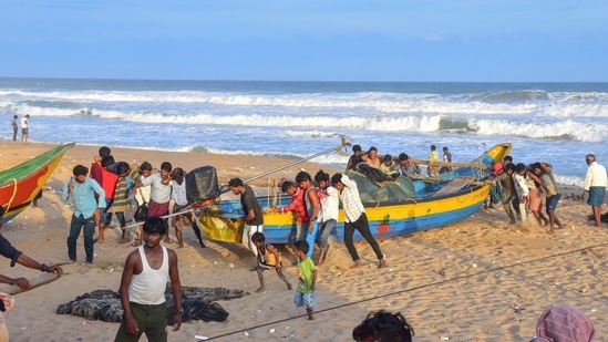 Fishermen park their boat on the shore after weather department issued an alert for coastal states regarding Cyclone Asani, at Puri beach.(PTI) Fishermen park their boat on the shore after weather department issued an alert for coastal states regarding Cyclone Asani, at Puri beach.(PTI)