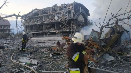 Emergency personnel work near a building damaged after a military strike, in Odesa, Ukraine, image released May 9, 2022.
