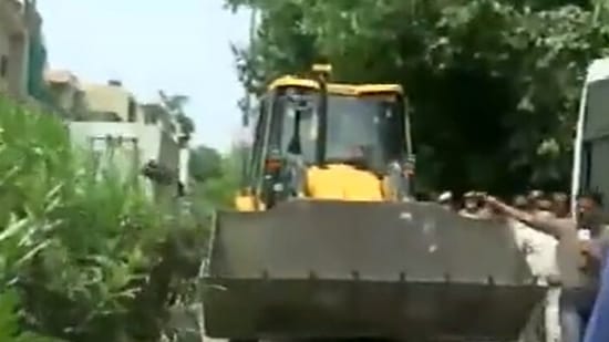 A bulldozer being brought to New Friends Colony in South Delhi on Tuesday. (ANI Twitter)