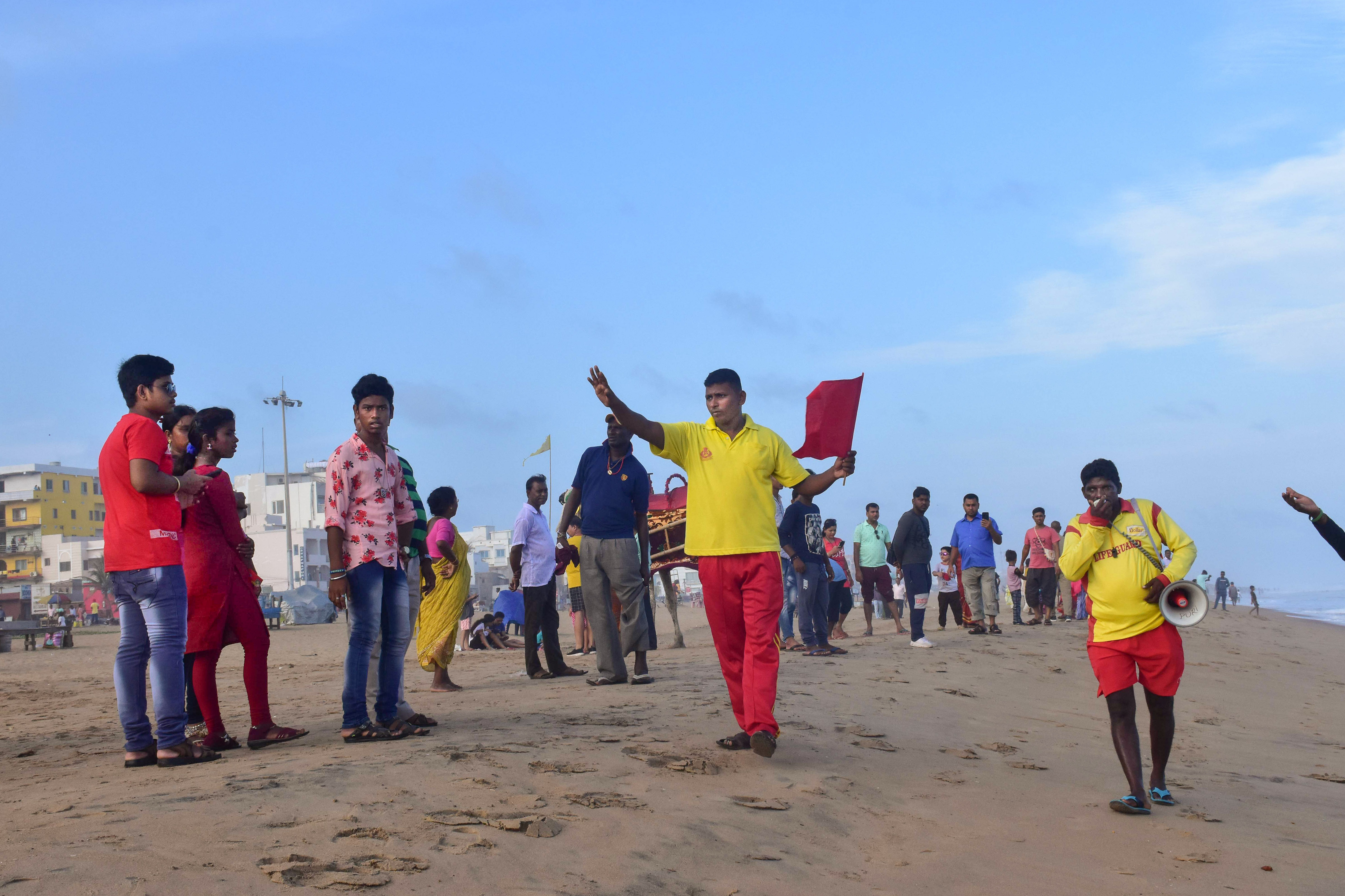 Beach guards urge people not to go near the sea, during Cyclone Asani in the Bay of Bengal, at Puri beach. (PTI) Beach guards urge people not to go near the sea, during Cyclone Asani in the Bay of Bengal, at Puri beach. (PTI)