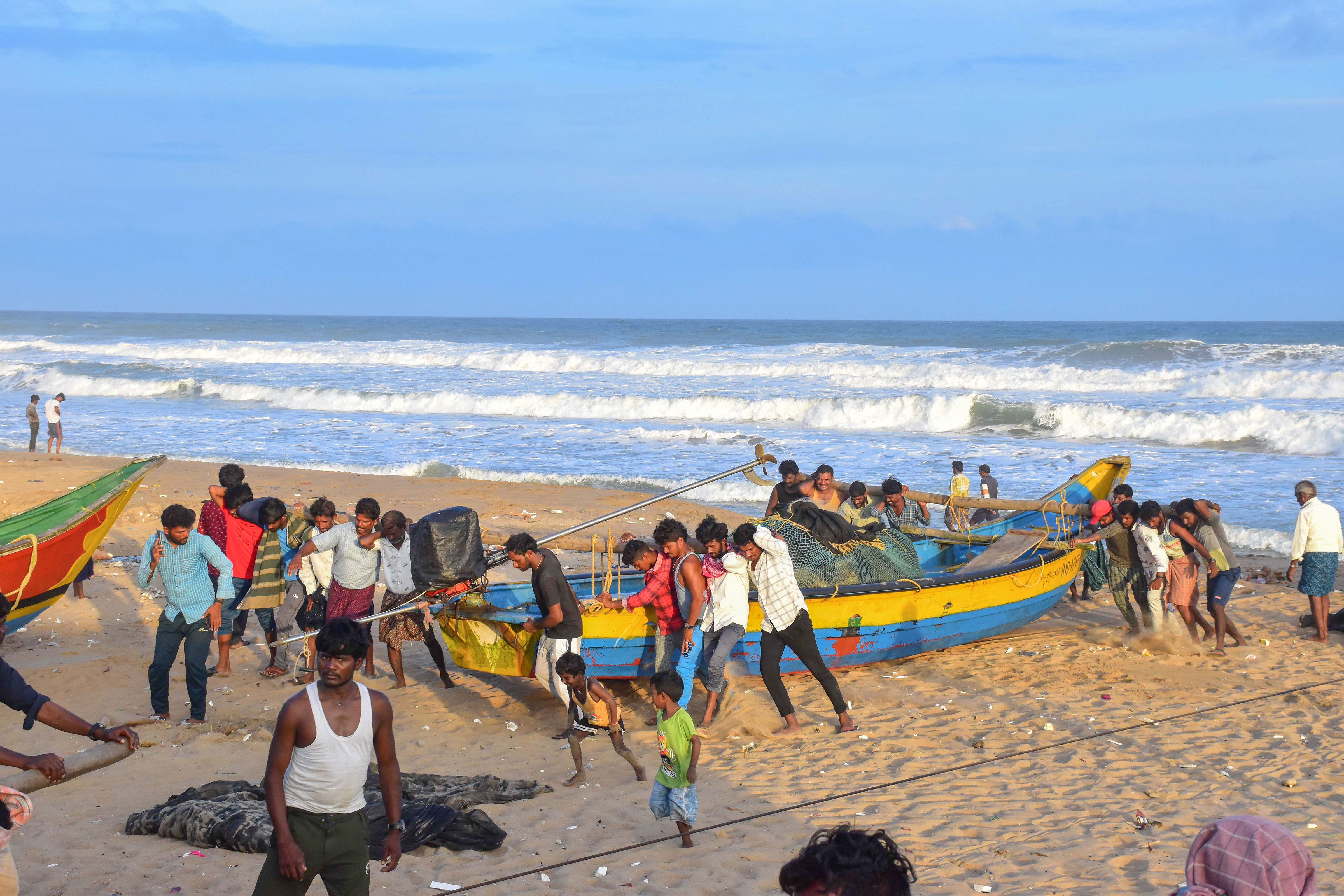 Fishermen park their boat on the shore after weather department issued an alert for coastal states regarding Cyclone Asani, at Puri beach. (PTI) Fishermen park their boat on the shore after weather department issued an alert for coastal states regarding Cyclone Asani, at Puri beach. (PTI)