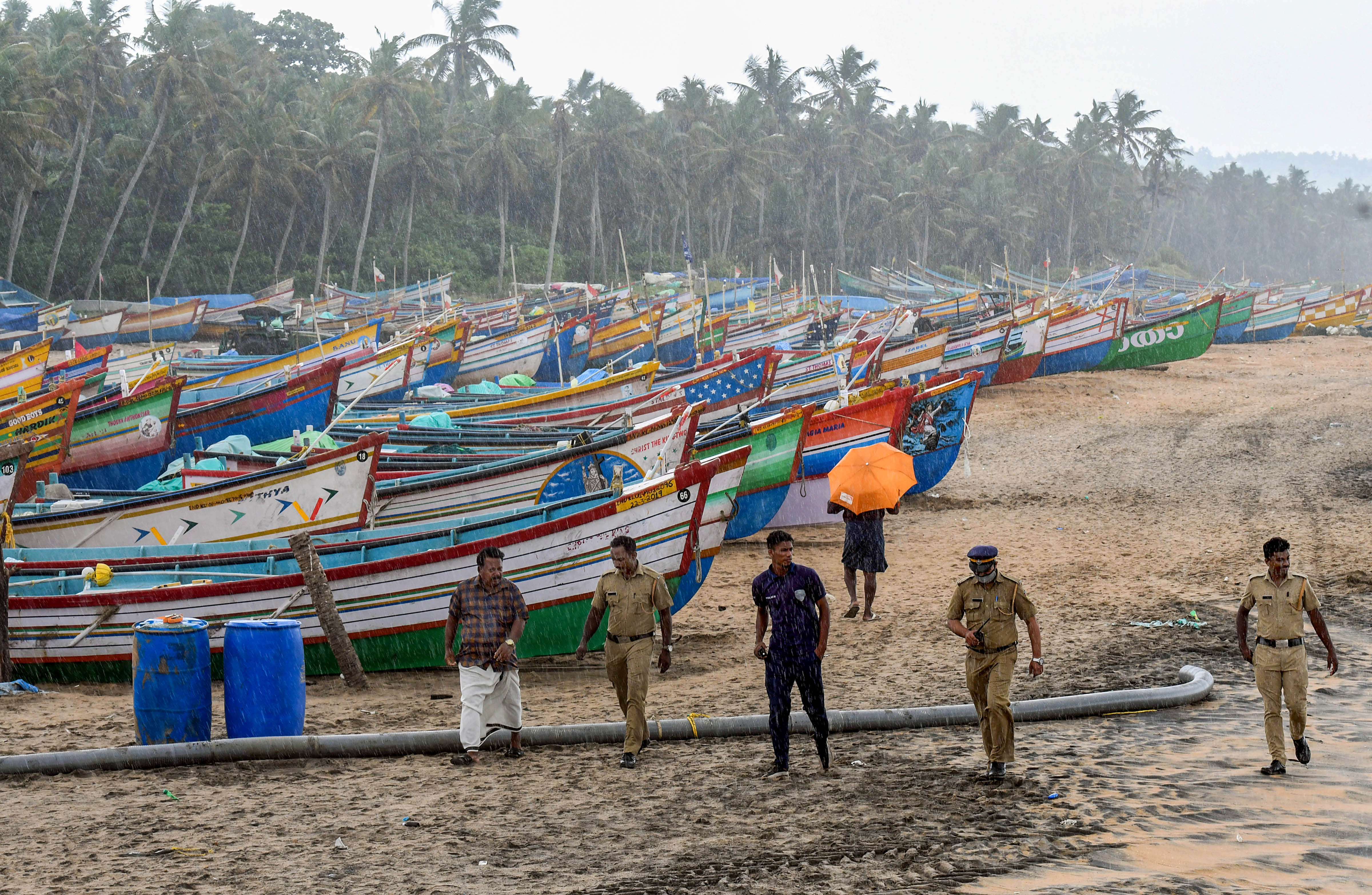 Police personnel keep vigil as part of precautionary measures against Cyclone Asani, at Poonthura coast in Thiruvananthapuram, Tuesday. (PTI) Police personnel keep vigil as part of precautionary measures against Cyclone Asani, at Poonthura coast in Thiruvananthapuram, Tuesday. (PTI)