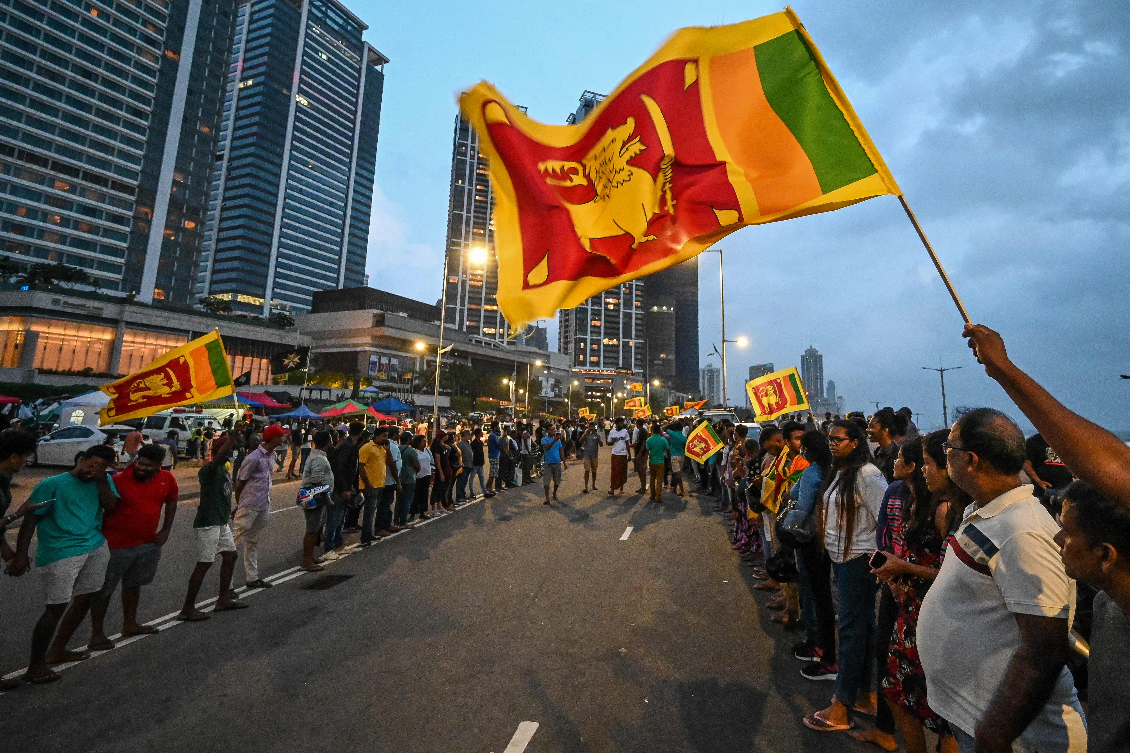 Anti-government demonstrators take part in a protest near the President's office in Colombo. (AFP) Anti-government demonstrators take part in a protest near the President's office in Colombo. (AFP)