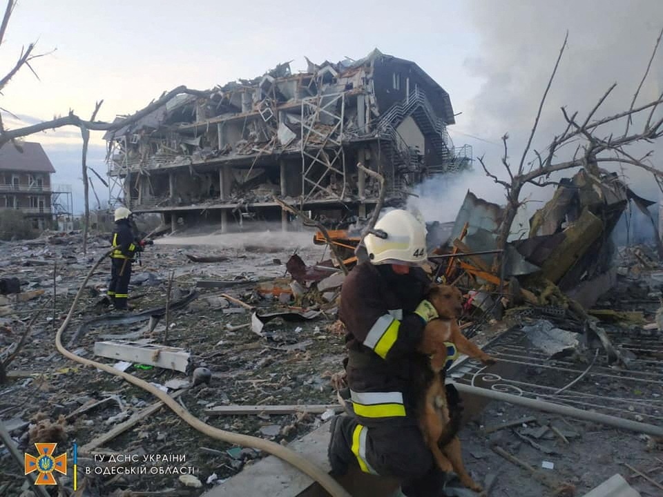 Emergency personnel work near a building damaged after a military strike, in Odesa, Ukraine. (via REUTERS)