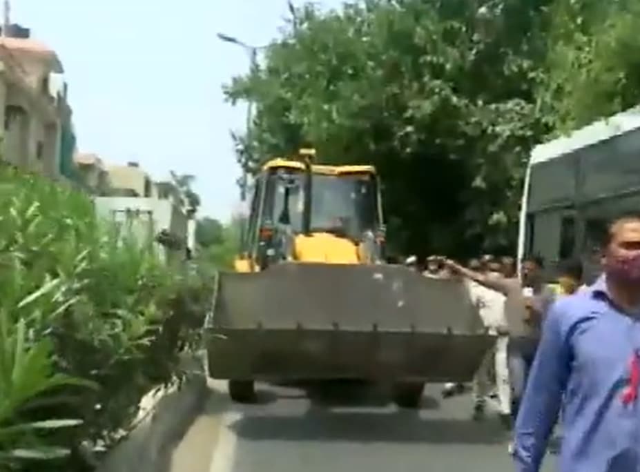 A bulldozer being brought to New Friends Colony in South Delhi on Tuesday. (ANI Twitter)
