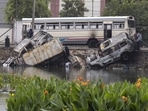 A damaged bus and burned out vehicles pushed into Beira Lake during protests in Colombo, Sri Lanka. A damaged bus and burned out vehicles pushed into Beira Lake during protests in Colombo, Sri Lanka.
