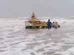 A video tweeted by agency ANI showed people on the shore dragging the chariot out of the water and bringing it to the shore. A video tweeted by agency ANI showed people on the shore dragging the chariot out of the water and bringing it to the shore.