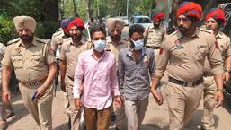 The accused in the Central Bank Of India robbery case in police custody, in Amritsar on Wednesday. (Sameer Sehgal /Hindustan Times)