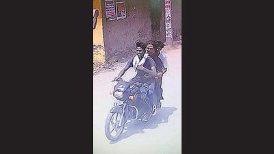 A CCTV grab of the robbers escaping on a bike. (Harvinder Singh/HT)