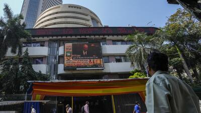 FILE - A man watches a screen showing Russian President Vladimir Putin on the facade of the Bombay Stock Exchange (BSE) building in Mumbai. (AP) FILE - A man watches a screen showing Russian President Vladimir Putin on the facade of the Bombay Stock Exchange (BSE) building in Mumbai. (AP)
