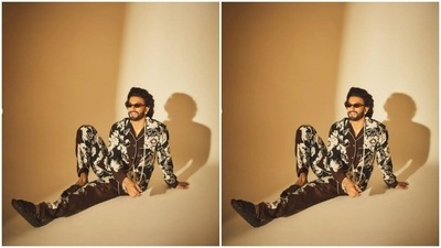 In black tinted shades and diamond ear studs, Ranveer sat on the floor and posed for the cameras. (Instagram/@ranveersingh)