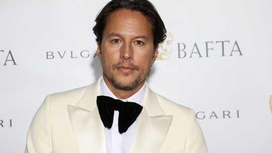 Cary Fukunaga poses for photographers upon arrival at the BAFTA Gala Dinner in London. (Photo by Vianney Le Caer/Invision/AP)(Vianney Le Caer/Invision/AP)