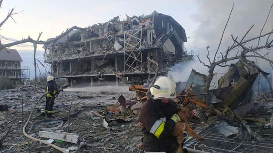 Emergency personnel work near a building damaged after a military strike, in Odesa, Ukraine
