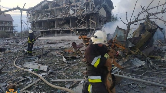 Emergency personnel work near a building damaged after a military strike, in Odesa, Ukraine.(via REUTERS)