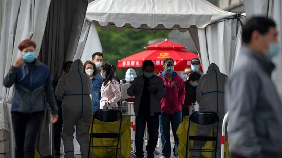 People wearing face masks stand in line for Covid-19 tests at a coronavirus testing site in Beijing.(AP) People wearing face masks stand in line for Covid-19 tests at a coronavirus testing site in Beijing.(AP)