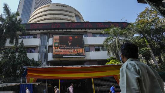 FILE - A man watches a screen showing Russian President Vladimir Putin on the facade of the Bombay Stock Exchange (BSE) building in Mumbai. (AP)