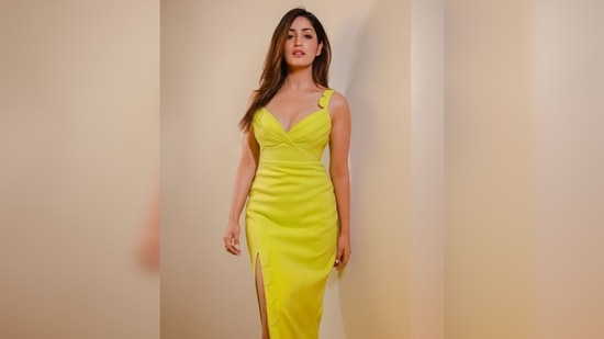Yami Gautam's dress features a plunging neckline with shoulder strap detailing and a thigh-high slit.(Instagram/@vandayafashionagency)