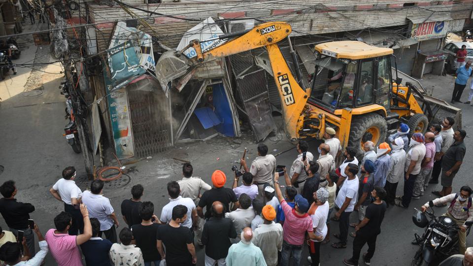 A bulldozer at work during an anti-encroachment drive by SDMC, at Chaukhandi in New Delhi on Wednesday. (Sanchit Khanna/HT Photo) A bulldozer at work during an anti-encroachment drive by SDMC, at Chaukhandi in New Delhi on Wednesday. (Sanchit Khanna/HT Photo)