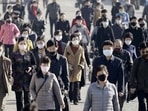 FILE PHOTO: People wearing protective face masks commute amid concerns over the new coronavirus disease (COVID-19) in Pyongyang, North Korea.