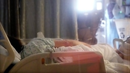 A Covid-19 patient lies in a bed in the acute care unit.&nbsp;