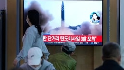 People watch a TV screen showing a news programme reporting about North Korea's missile launch with file footage, at a train station in Seoul, South Korea, Thursday, May 12, 2022. (AP/PTI)