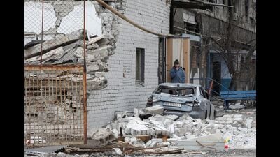 A local resident stands near an apartment building damaged during Ukraine-Russia conflict in Mariupol, Ukraine, 2022 (REUTERS) A local resident stands near an apartment building damaged during Ukraine-Russia conflict in Mariupol, Ukraine, 2022 (REUTERS)