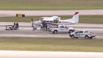 In this still image from video by WPTV shows emergency personnel surrounding a Cessna plane at Palm Beach International Airport Tuesday. (AP)