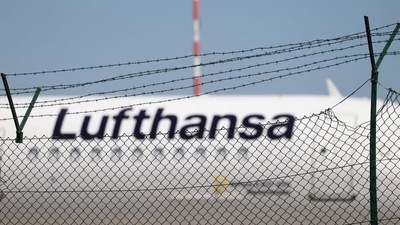 A Lufthansa jet is seen behind a barbed-wire fence at the airport&nbsp; (REUTERS)