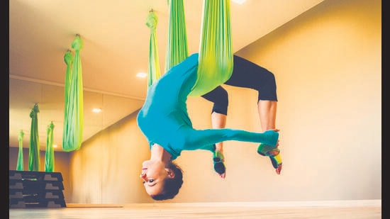 Premium Photo | Woman doing poses in air hammock, anti-gravity yoga.