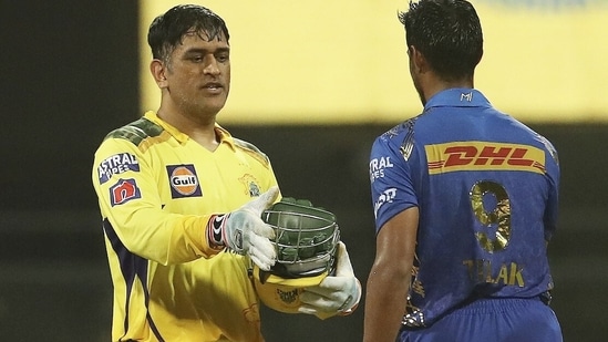 MS Dhoni, captain of Chennai Super Kings and N. Tilak Varma of Mumbai Indians during the 59th T20 cricket match of the Indian Premier League 2022(PTI)