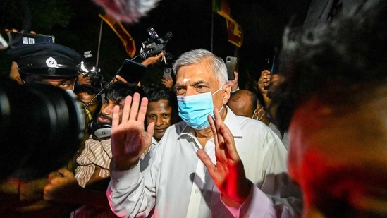 Sri Lanka's new prime minister Ranil Wickremesinghe visits a Buddhist temple after his swearing-in ceremony in Colombo on Thursday. (AFP)