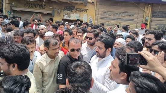 AAP MLA Amanatullah Khan and his supporters, in south Delhi's Madanpur Khadar area.(HT Photo)