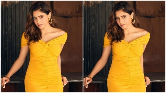 Aamna’s short yellow dress came with off-shoulders and a knot detail. She accessorised her look with golden earrings.(Instagram/@aamnasharifofficial)
