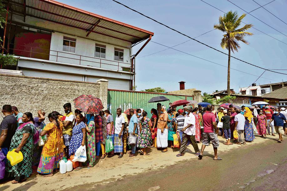 Sri Lankans wait in a queue to buy kerosene oil for cooking outside a fuel station in Colombo. (REUTERS) Sri Lankans wait in a queue to buy kerosene oil for cooking outside a fuel station in Colombo. (REUTERS)