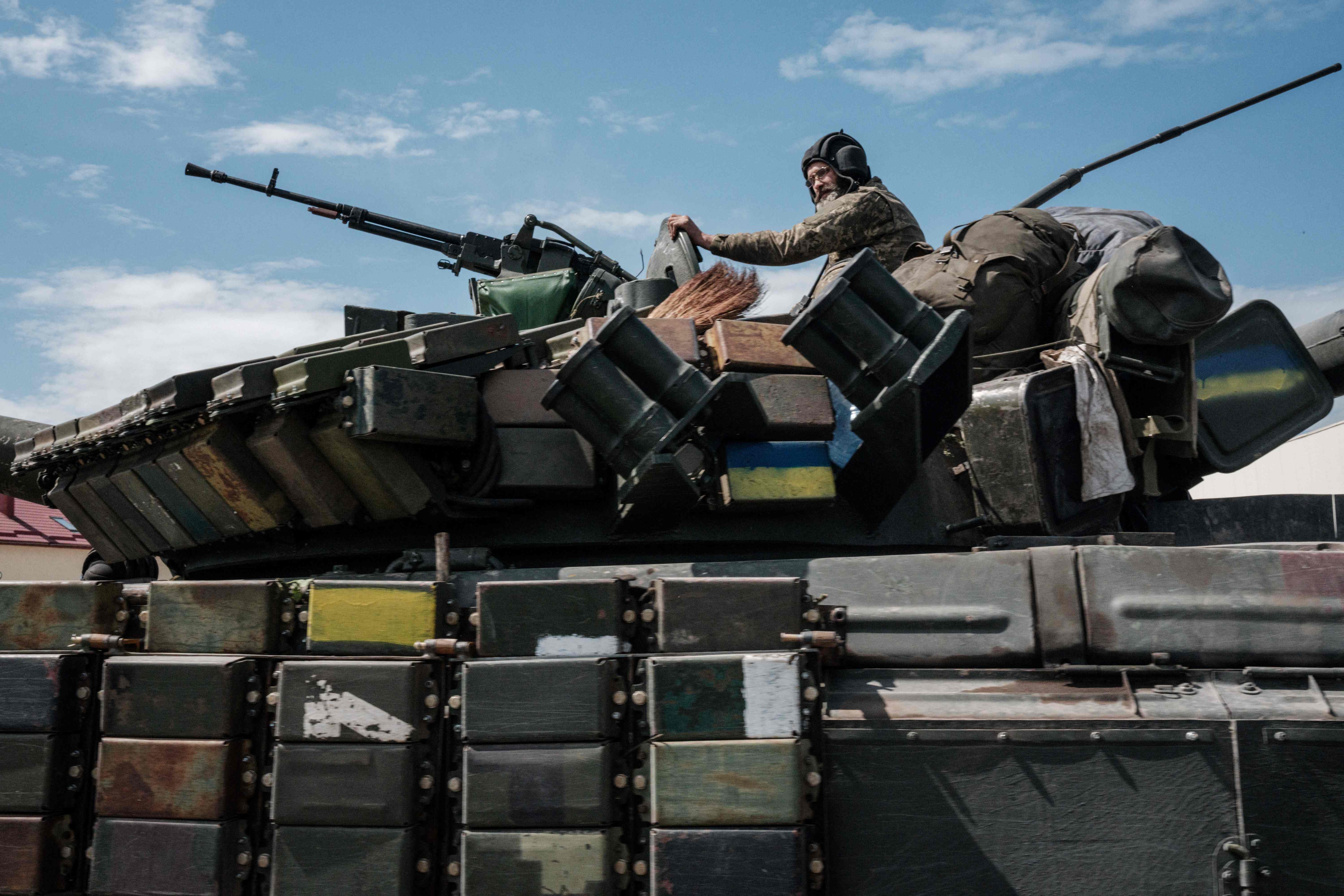 A Ukrainian soldier sits on a tank carryied by a transporter near Bakhmut, eastern Ukraine, on May 12, 2022. (AFP) A Ukrainian soldier sits on a tank carryied by a transporter near Bakhmut, eastern Ukraine, on May 12, 2022. (AFP)